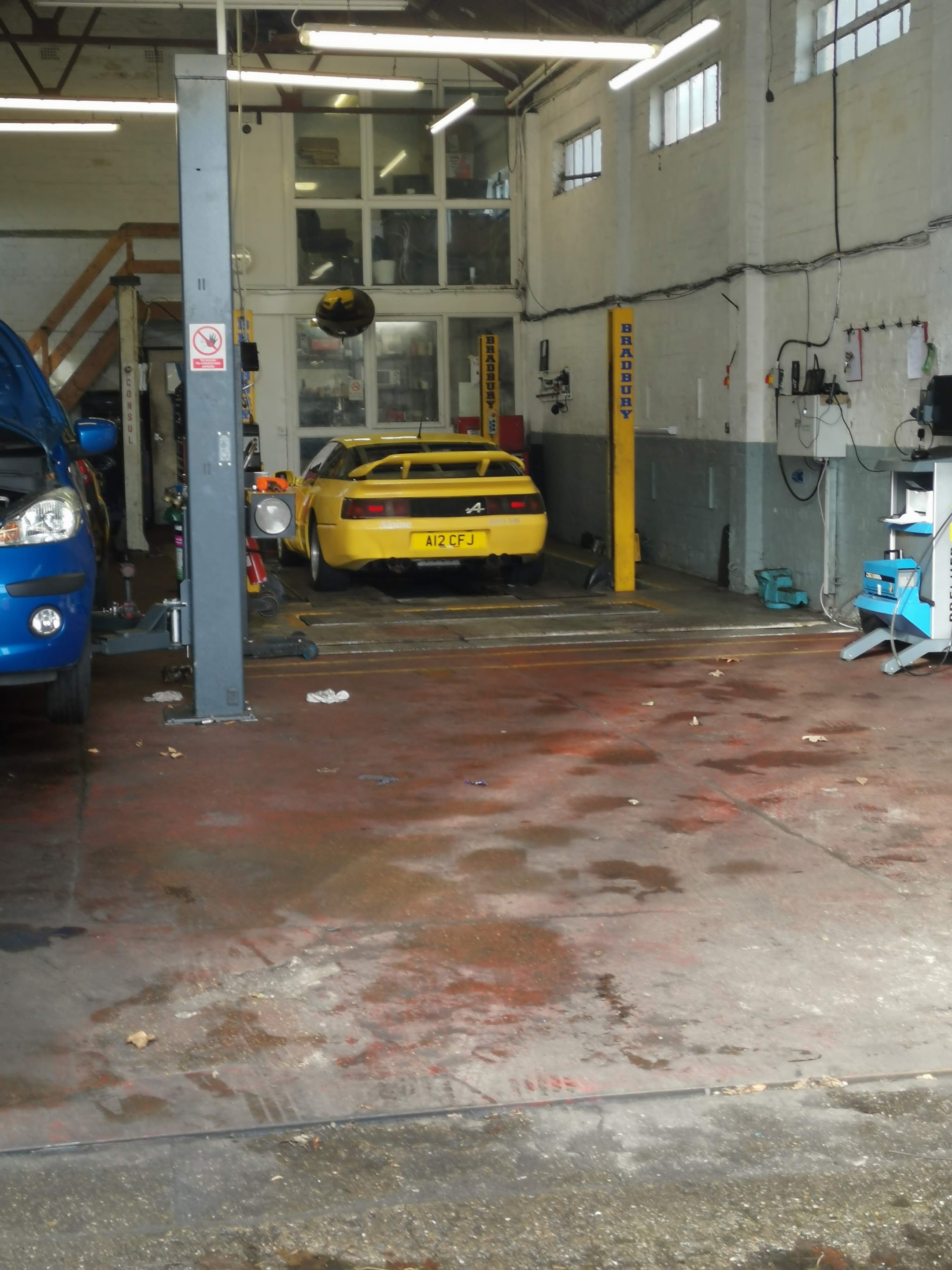 Looking into the Lunts Motors workshop, with the lift posts and a car in the back bay