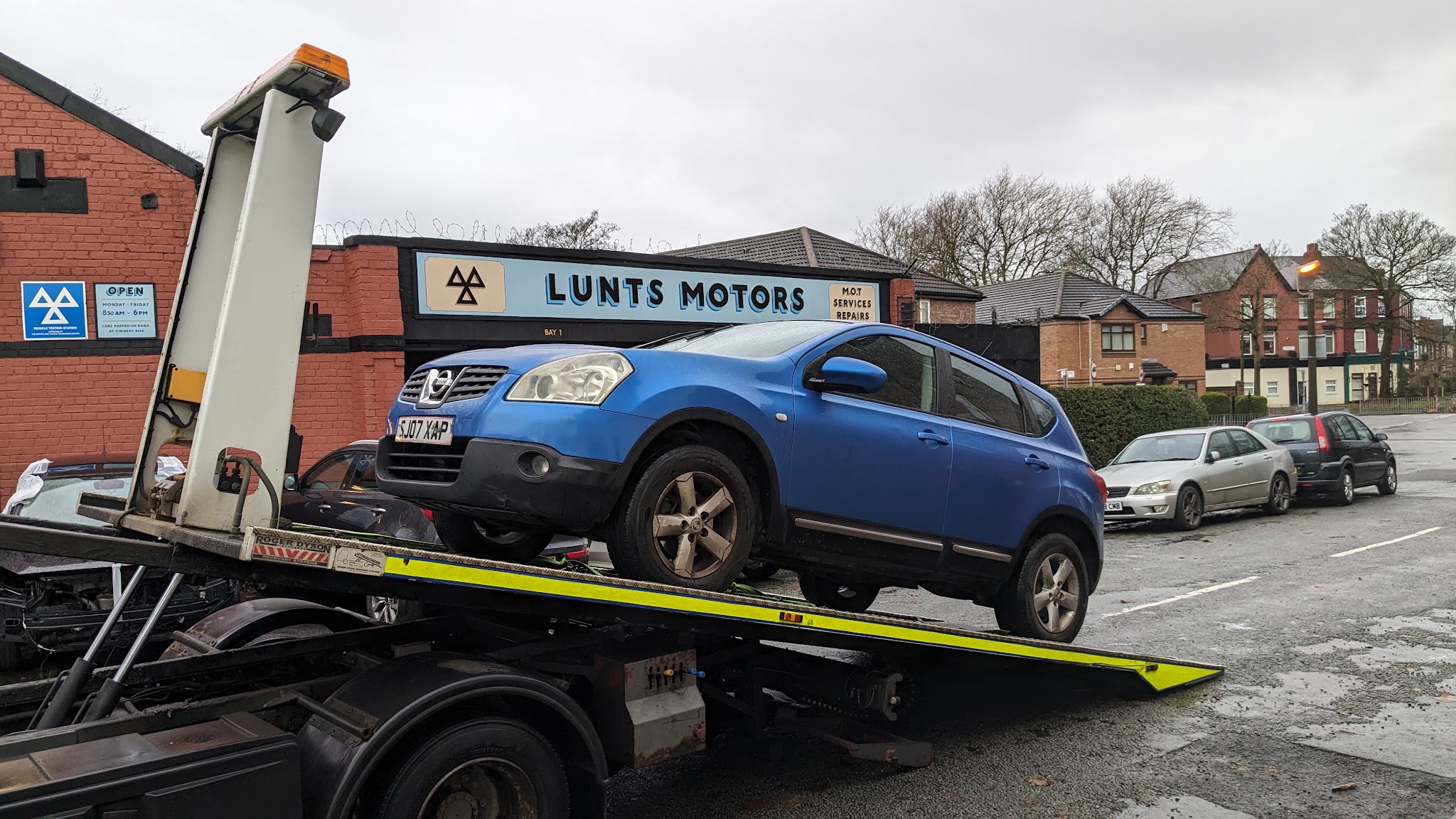 Lunts Motors from the street, with its sign reading M.O.T, Services, Repairs